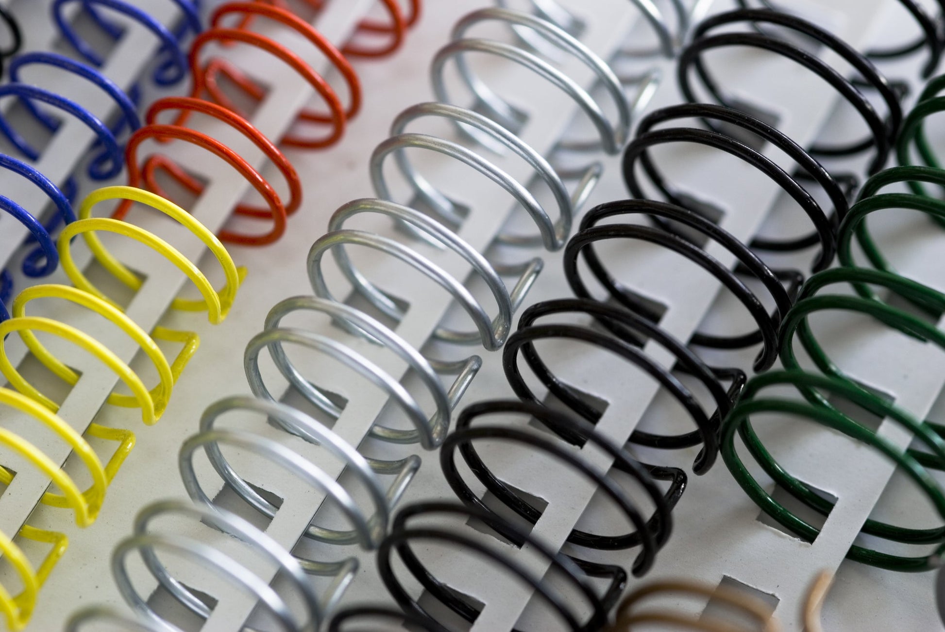 Close up of wire binding for a black and white printed report or dissertation